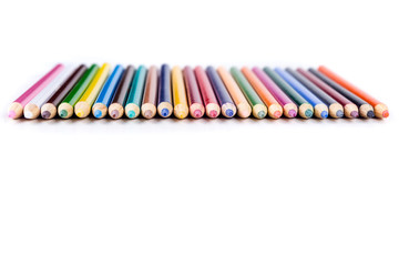 Line of assorted colored pencils isolated on white background