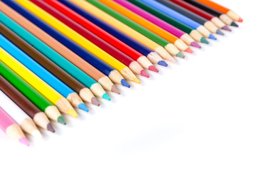 Line of assorted colored pencils isolated on white background