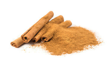 Stack of cinnamon sticks and ground cinnamon isolated on white background