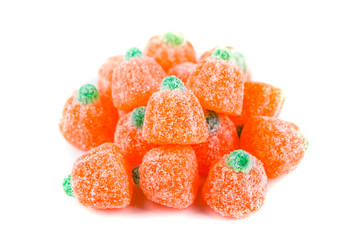 Pile of sour pumpkin chewy candies isolated on white background