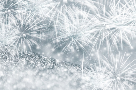 Silver and dark blue fireworks and bokeh on gliter paper at New Year and copy space. Abstract background holiday.