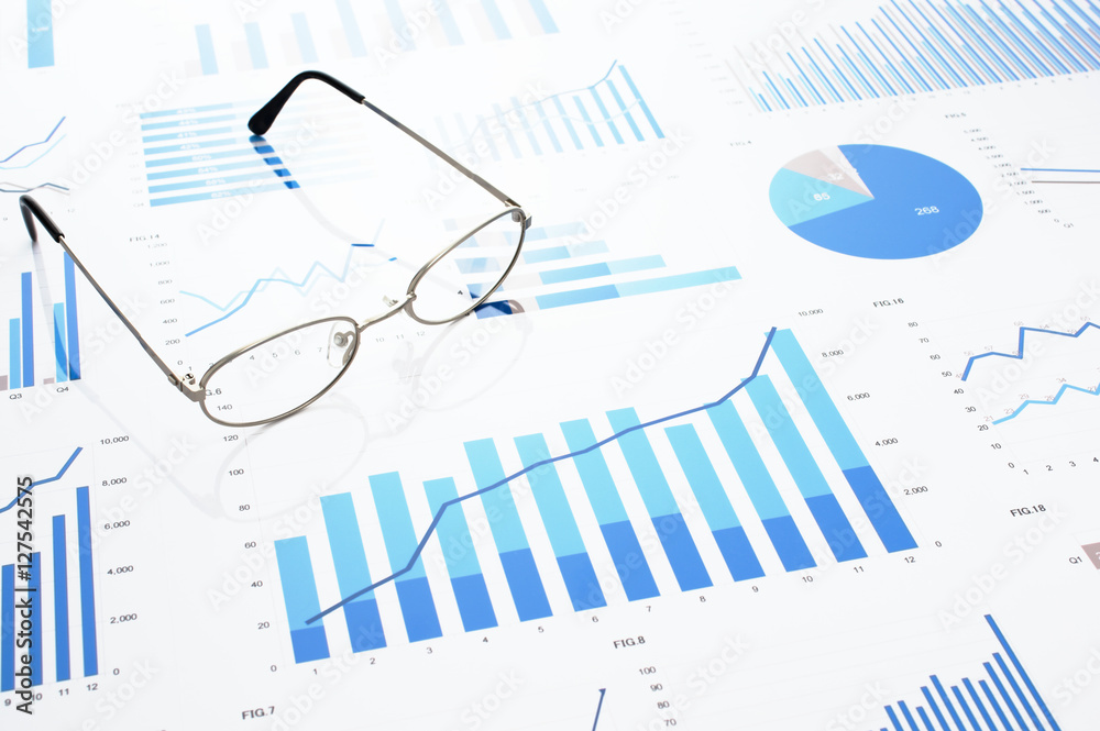 Aufkleber many charts and glasses. reviewing data.　financial reports and glasses. reflection background.