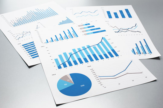 Business documents. Graphs and charts.　Documents on gray reflection background.
