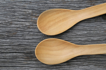 Wooden spoon on brown wood floors.