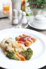  Fried rice and sausage on white dish.