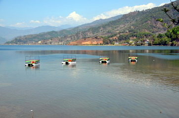 Fototapeta na wymiar Four catamaran boats on the Phewa lake in Pokhara, Nepal