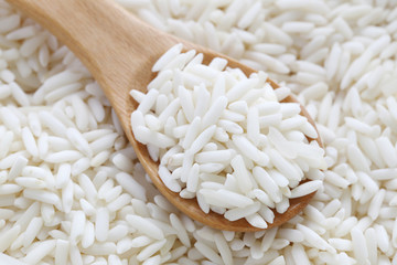 Organic white rice in wooden spoon, glutinous rice or sticky ric