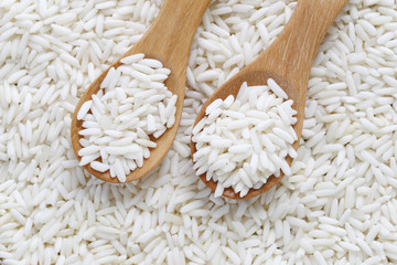 Organic white rice in wooden spoon, glutinous rice or sticky ric