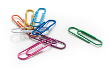 Colored paper clips on a white background. Top view.