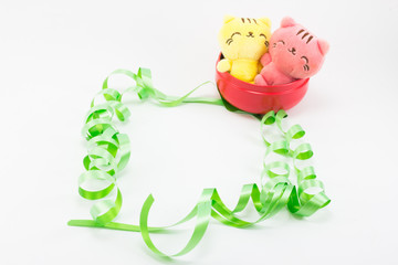 Yellow pink teddy cat on red gift box and green ribbon  white ba
