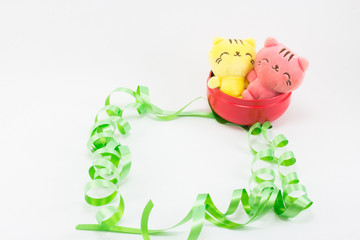 Yellow pink teddy cat on red gift box and green ribbon  white ba