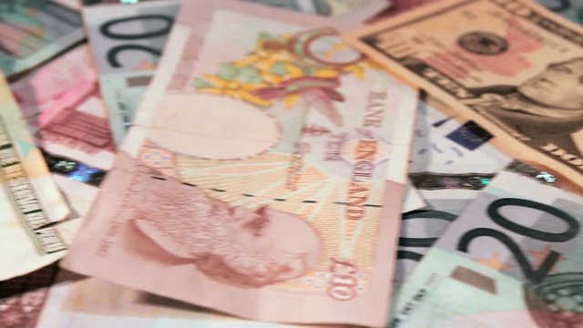 Smooth slide shot of different currency notes including American dollars, British Pounds and Euro Dollars. - Powered by Adobe