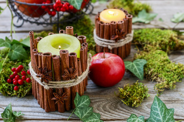 Candle decorated with cinnamon sticks