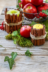 Candle decorated with cinnamon sticks