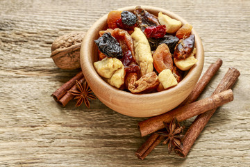 Bowl of dried fruits on wood