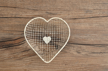 Valentine's Day. A white wire basket in a shape of a heart