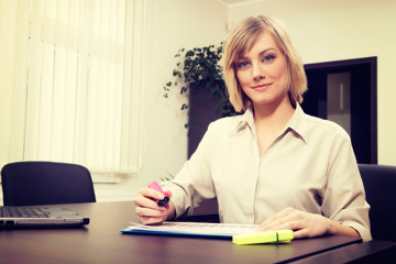 Blonde businesswoman highlighting chart. Business concept