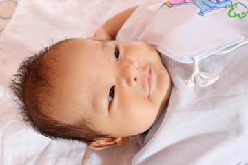 Asian baby smiling happily and good mood.