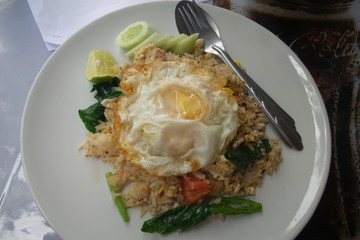 Fried rice with fried chicken with fried chicken on white plate