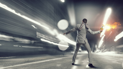 Obraz premium Businessman throwing petrol bomb . Mixed media