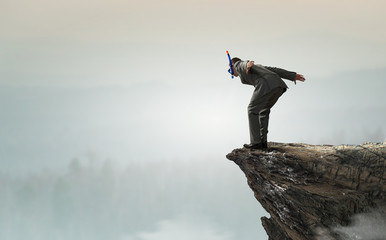Businessman diving from top . Mixed media