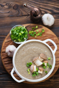 Cream-soup with porcini mushrooms on a wooden background