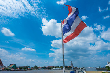 Thailand flag blowing in the wind above the river under the beau
