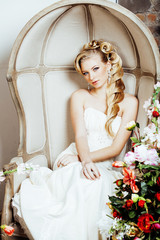 beauty young bride alone in luxury vintage interior with a lot of flowers close up