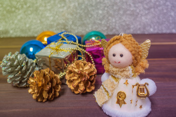 Little Angel Christmas gift boxes among small on the wooden back