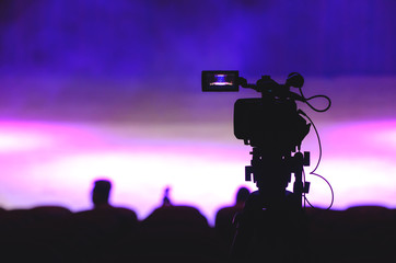 Video recorder silhouette in front of stage before show begins