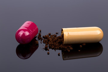 Orange antibiotics capsule powder on the black background