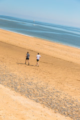Two friends run  on beach