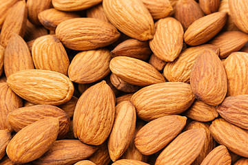 Fototapeta premium Almonds background. Pile of selected almonds close-up. For vegetarians.