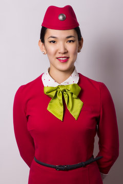 Beautiful Asian Flight Attendant On Grey Background 