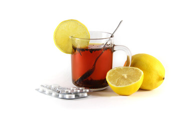 hot drink with a lemon with drugs for colds and flu, isolated on