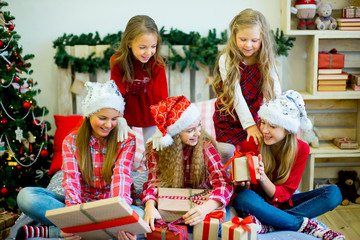Group of kids in red hat with Christmas gifts