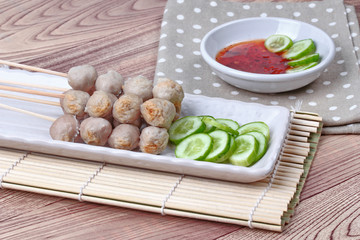 Close up,Grilled pork meatball skewers served. Selective focus.