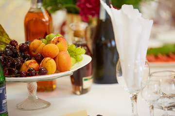 tasty fruit on a plate with pears, grapes, apricots