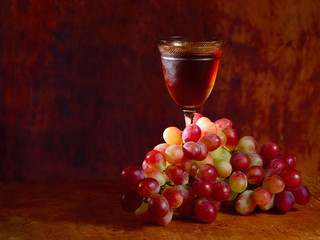 bunch of red grape and wine glass