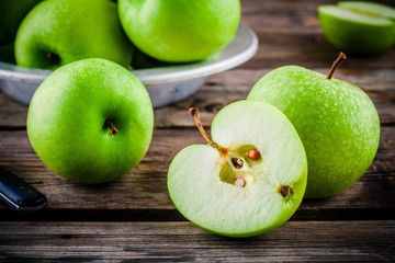 organic green apples on rustic wooden background