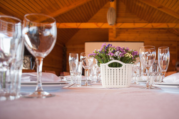    table setting in restaurant with flowers and wineglasses