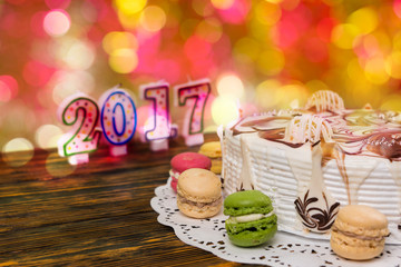 Cake for new year and christmas with macarons, candles number 20
