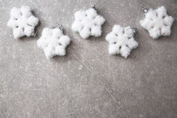 Christmas card with silver balls and stars on the blue wooden ta