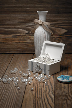 Casket with pearls on a wooden background