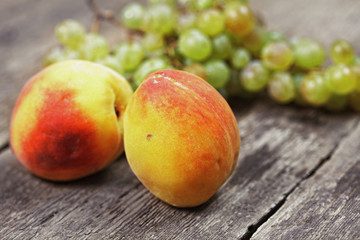 Two peaches and bunch of grapes