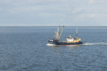 Fishing boat on the Wadden Sea .