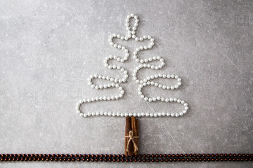 Christmas tree of pearls, cinnamon sticks and Christmas balls. T