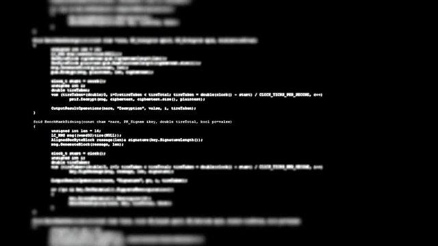 Showing a flow of source code text (instructions for a computer program) on a PC screen in tilt-shift. White characters, black background.

