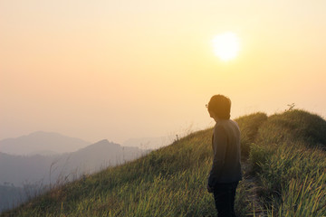 Man on the top of the hill watching wonderful scenery in mountains during summer colorful in Thailand. Vintage filtered image.