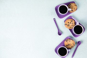 Purple coffee cup with saucer and spoon on light blue background